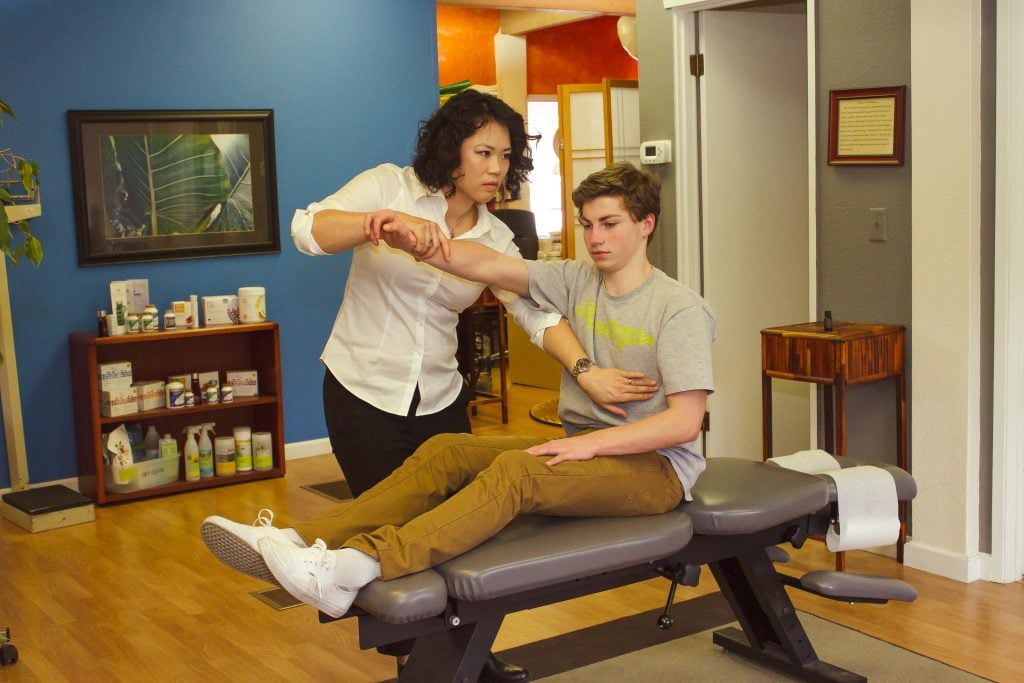 Chiropractor treating a patient at Color Chiropractic Bellingham